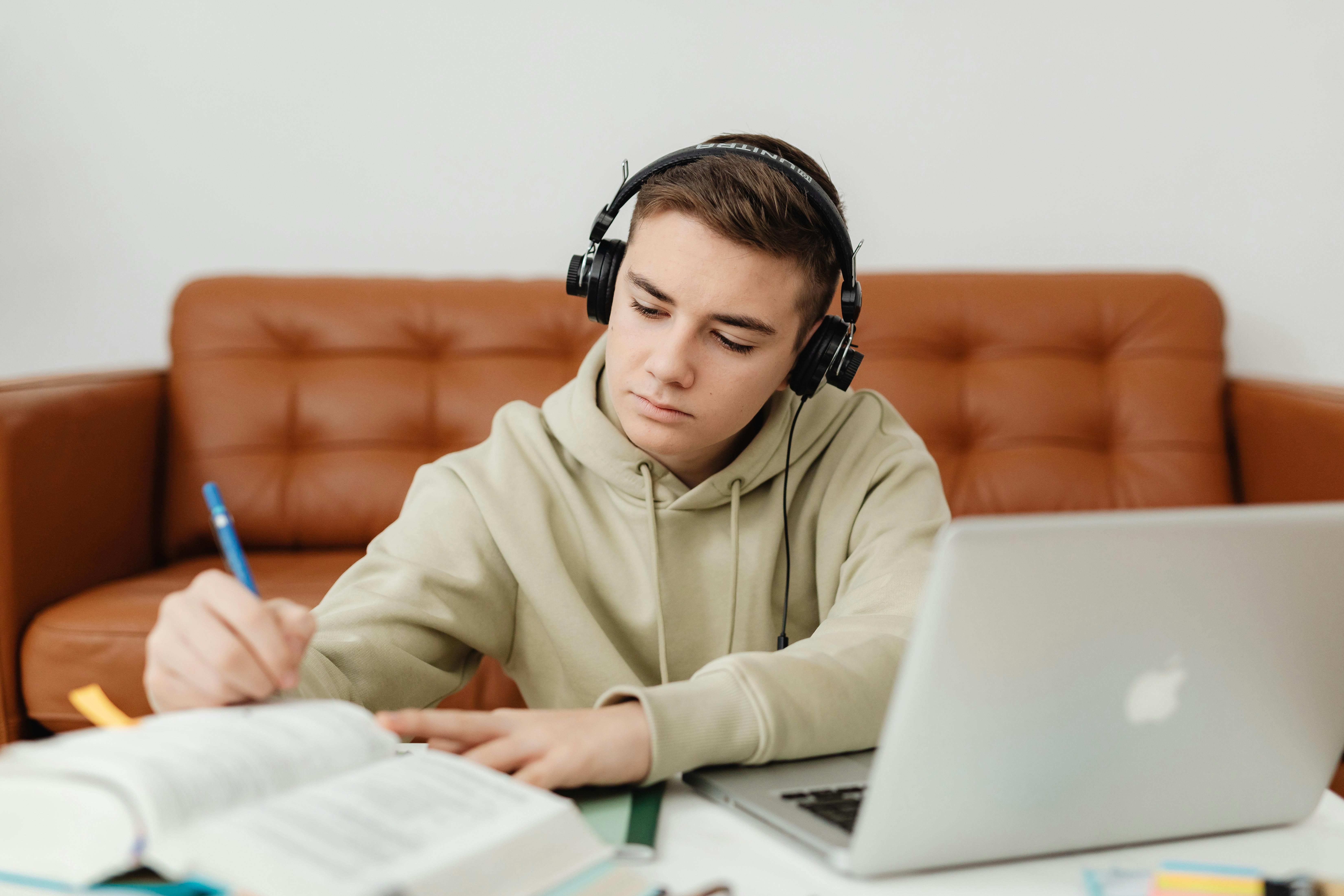 A teenage boy studying at his desk.